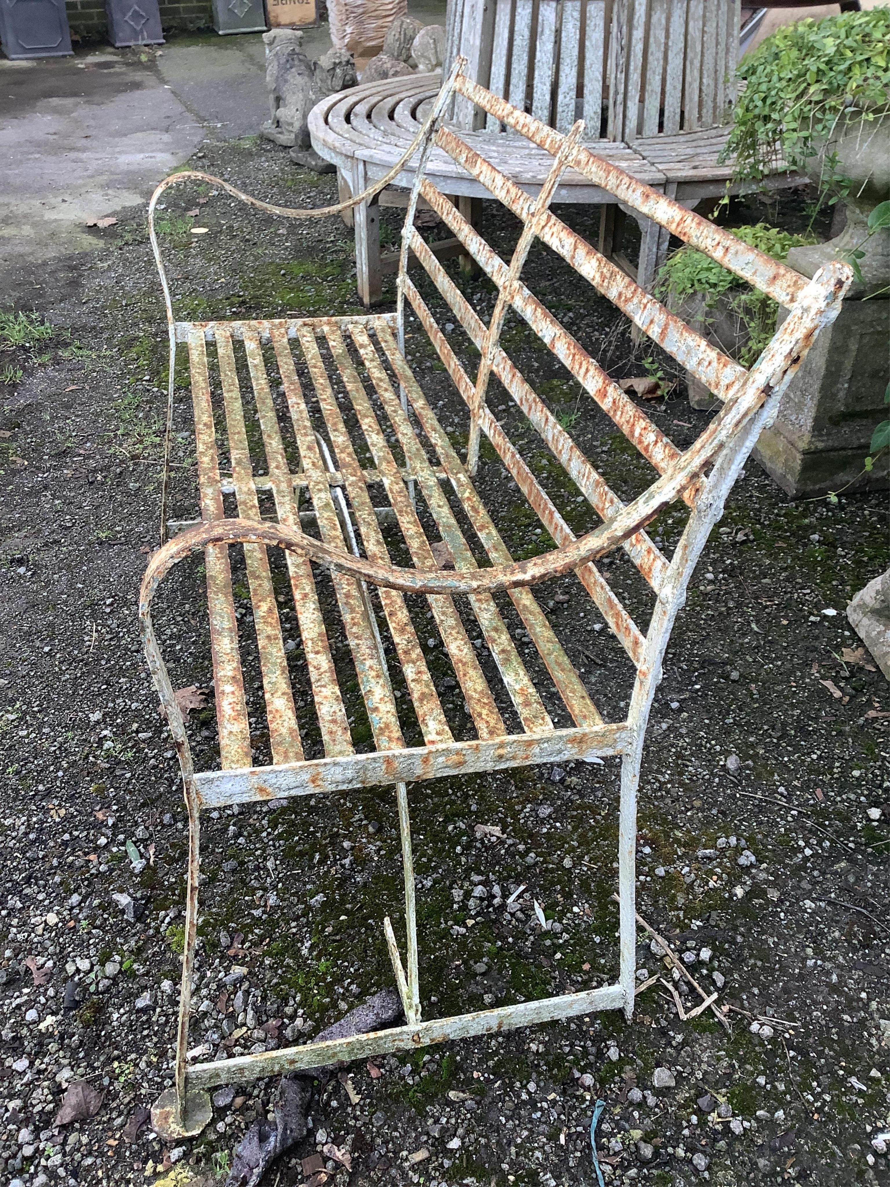 A 19th century white painted slatted wrought iron garden bench, width 122cm, depth 45cm, height 88cm. Condition - poor to fair